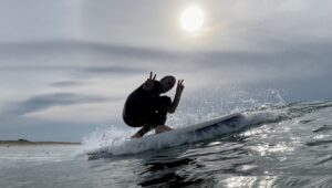 Surfer riding a wave on a sunny day.