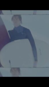 Man holding two surfboards